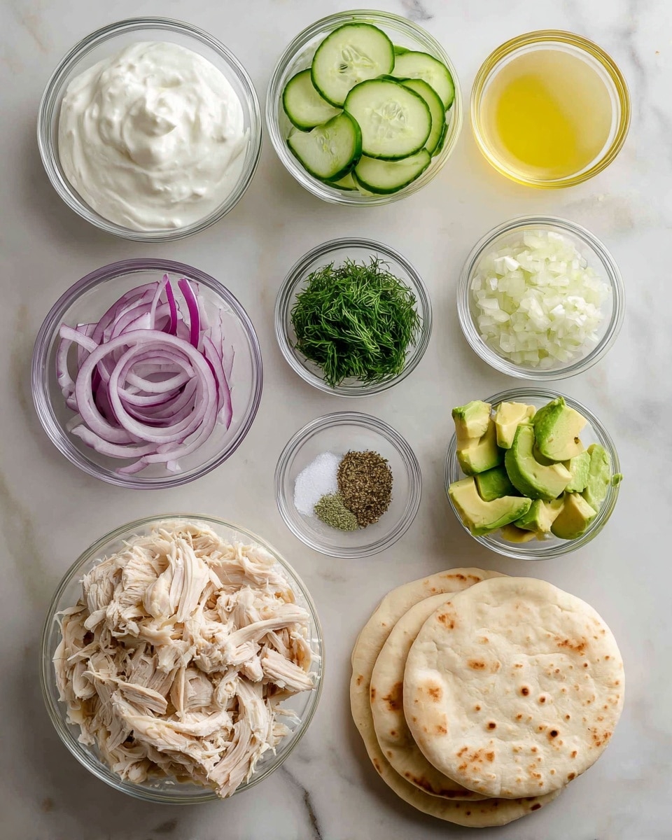 The image shows an organized layout of ingredients for a meal on a white marbled surface. There are several clear glass bowls, each containing a different item: thick white Greek yogurt on the top left, pale green sliced English cucumber next to it, and light yellow lemon juice on the top right. Below them are small bowls with finely chopped white garlic, fresh green dill, and a mix of salt and pepper. A larger bowl on the left holds shredded light beige rotisserie chicken, while a smaller bowl in the center contains thinly sliced purple-red onion. To the right is a bowl with bright green avocado slices. In the bottom center, there are three round beige pita breads stacked on top of each other. The whole scene is clean and brightly lit. Photo taken with an iphone --ar 4:5 --v 7