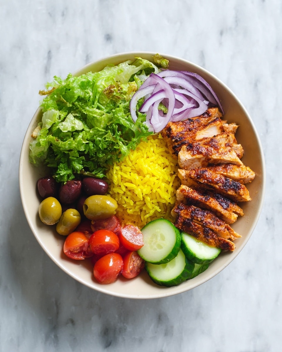 The dish is served in a white bowl with a layer of yellow rice as the base, covering half of the bowl. On top of the rice, there is a layer of grilled chicken pieces placed in a neat row on the right side, showing a golden-brown crispy texture. Above the rice, on the top left side, there is a portion of bright green leafy lettuce. Below the lettuce, thin slices of purple onion add a pop of color. Moving further left, there are five olives of green, brown, and black colors grouped together. At the bottom left, halved red cherry tomatoes are displayed next to slices of fresh cucumber with light green skin and white flesh, arranged toward the front of the bowl. The bowl is placed on a white marbled surface. Photo taken with an iphone --ar 4:5 --v 7