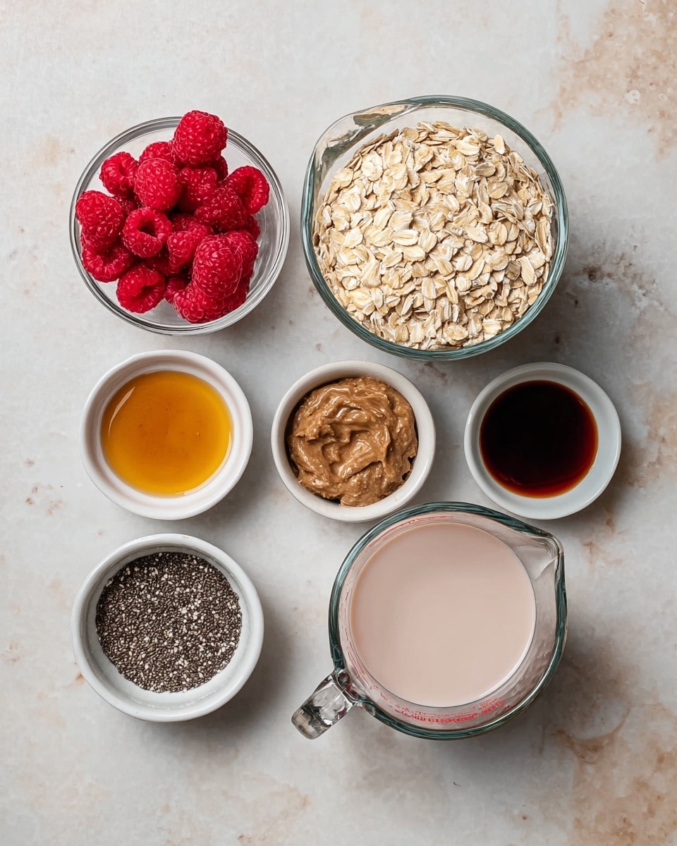 The image shows six containers arranged neatly on a white marbled surface. There are two glass measuring cups filled with light beige rolled oats and a pale pink liquid, positioned on the right side of the image. To the left, five small white bowls hold different ingredients: one with bright red raspberries, one with dark brown nut butter, one with black chia seeds, one with amber-colored syrup, and one with dark brown vanilla extract. The textures range from smooth liquids to rough oats and rounded raspberries. photo taken with an iphone --ar 4:5 --v 7