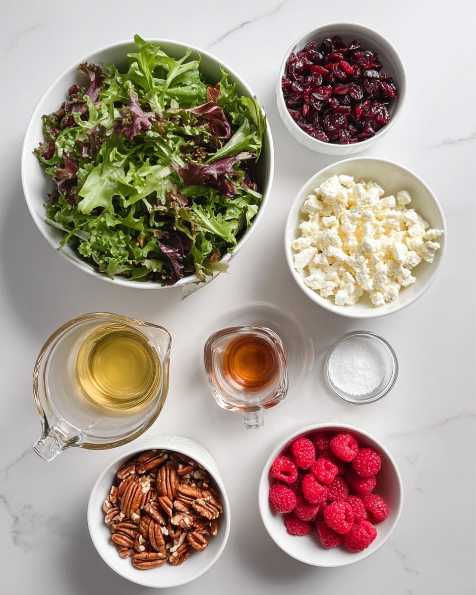 The image shows several small white bowls and a larger white bowl arranged on a white marbled surface. The largest bowl on the left is filled with mixed leafy greens in green and purple shades, textured and curly. To the right, starting from the top, there are small white bowls filled with dark red dried cranberries, crumbled white cheese with a soft texture, roughly chopped brown pecans with a rough texture, and fresh red raspberries with a smooth yet bumpy surface at the bottom. Below the pecans and cheese bowls, there are three small containers: a clear glass measuring cup filled with light golden olive oil, a tiny white bowl with white salt crystals, and a very small empty white bowl. There is also a tiny clear cup with a light brown liquid near the oil container. The bowls and cups are neatly placed with even spacing, creating a clean and organized layout. Photo taken with an iphone --ar 4:5 --v 7