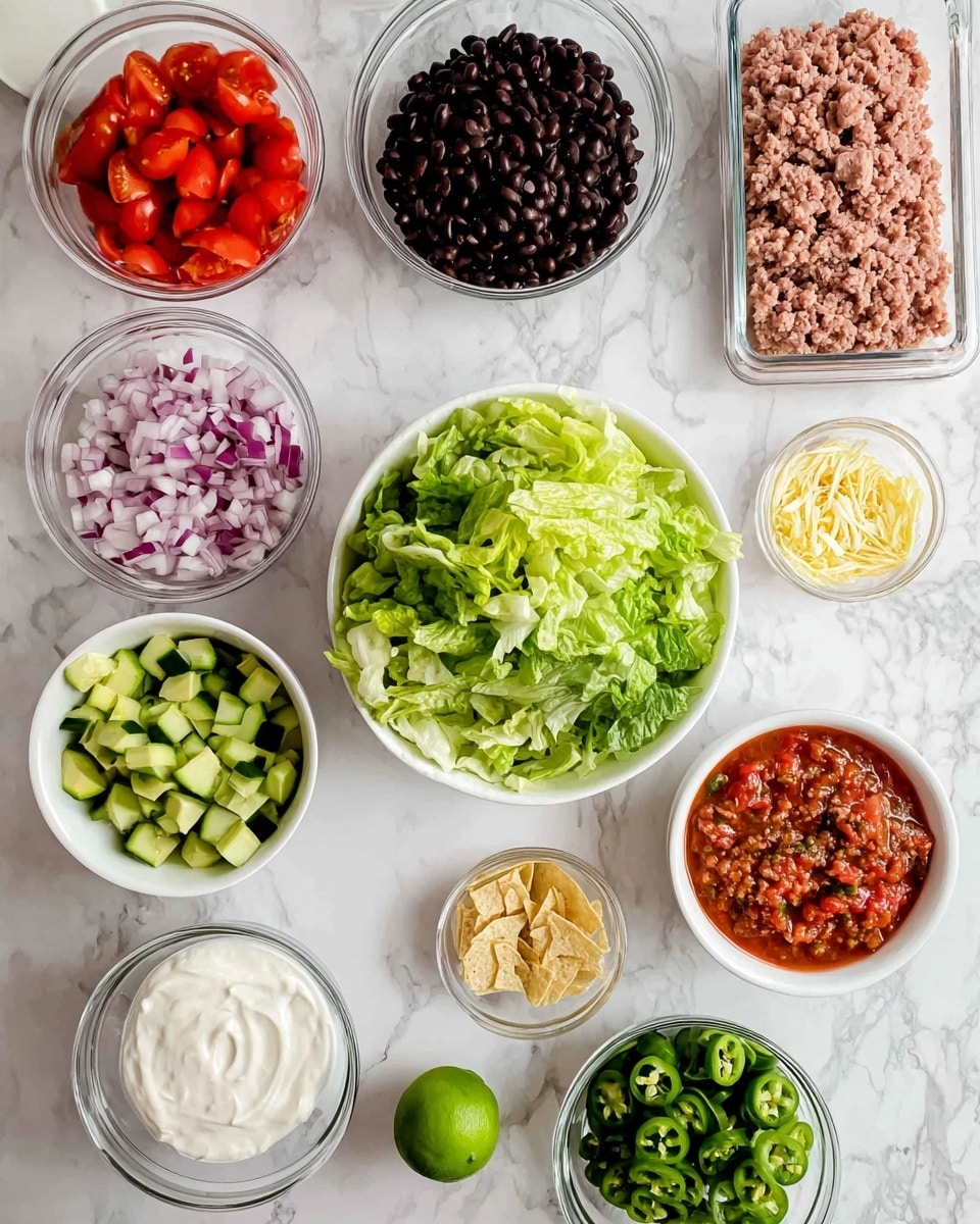 The image shows many white bowls and containers on a white marbled surface, each holding different fresh ingredients arranged clearly. There is a pack of light pink ground meat in the top right and a clear measuring cup filled with black beans in the top left. Below these, there is a white bowl of bright green chopped romaine lettuce in the center, surrounded by chopped cucumbers in a white bowl to the upper left, chopped red onions in a white bowl to the upper right, halved red grape tomatoes still in a clear plastic container to the left, and diced green avocado pieces in a white bowl at the bottom left. There is a small white bowl filled with sour cream next to the avocado, a small white bowl filled with chunky red salsa at the bottom right, a white bowl with spicy chopped green jalapeños near the center bottom, and a small clear bowl of golden crushed tortilla chips or crumbs near the middle right. A halved lime with light green flesh sits below the salsa bowl. The photo taken with an iphone --ar 4:5 --v 7