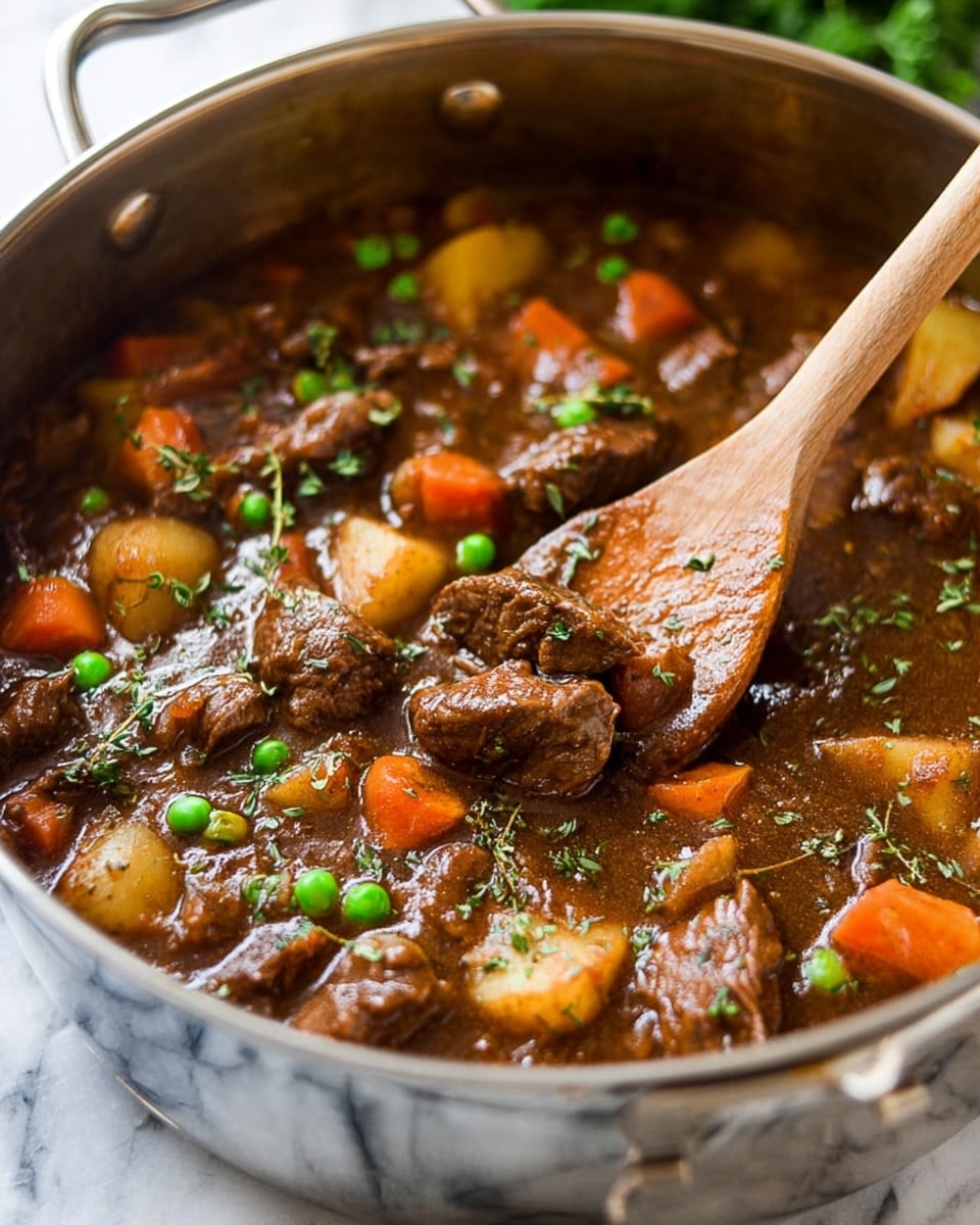 The image shows a close-up of a large metal pot filled with a thick brown stew. The stew has several layers: tender chunks of dark brown meat spread evenly, bright orange carrots and light yellow potatoes mixed in, and small green peas scattered on top. Fresh bits of green herbs are sprinkled over, adding a touch of freshness. A wooden spoon with some stew on it rests inside the pot, lifting a piece of meat. The pot sits on a white marbled surface with some greenery blurred in the background. photo taken with an iphone --ar 4:5 --v 7