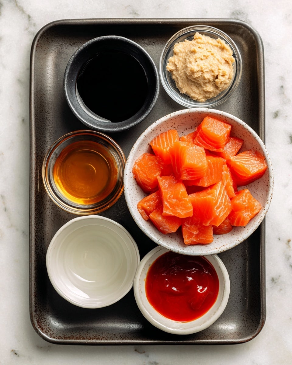 A dark metal tray holds six small bowls arranged neatly on a white marbled surface. In the center right is a white speckled bowl filled with bright orange cubed salmon showing a fresh, smooth, and glossy texture. To the upper right of the salmon bowl is a small clear bowl with creamy beige garlic paste. To the upper left is a small black bowl filled with dark soy sauce or tamari. Below the soy sauce is a small light beige bowl with golden honey, and next to it, at the lower center, is a small white bowl filled with clear water. At the lower right corner is a small bowl with bright red sriracha sauce. The bowls are arranged in a balanced, clean layout on the tray. Photo taken with an iphone --ar 4:5 --v 7