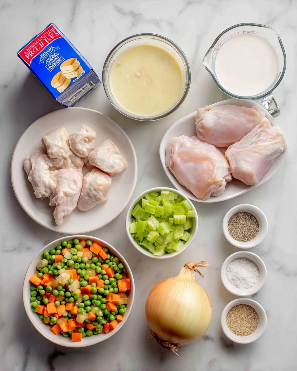 The image shows a white marbled surface with several ingredients arranged neatly. On the top left is a blue and red box of biscuits. Next to it is a small glass container with creamy light yellow soup. Above center is a clear measuring cup filled with white milk. To the right, on a white plate, are three raw light pink chicken pieces. Below the milk is a measuring cup filled with chopped bright green celery. Near the center bottom is a whole yellow onion with light brown skin. To the left is a white bowl filled with mixed frozen vegetables that are green, orange, and yellow. To the right are three small white bowls holding salt and pepper, light beige garlic powder, and more seasoning. The photo taken with an iphone --ar 4:5 --v 7
