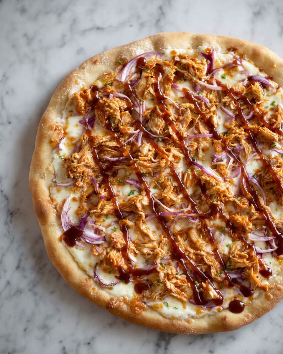 A round pizza with a light golden crust shows three main layers. The bottom layer is a creamy white cheese spread evenly across the surface. The middle layer consists of shredded orange-brown chicken pieces scattered thickly. The top layer has thin slices of red onion and drizzles of dark brown barbecue sauce spread unevenly. The pizza is set on a surface with white marbled texture. photo taken with an iphone --ar 4:5 --v 7