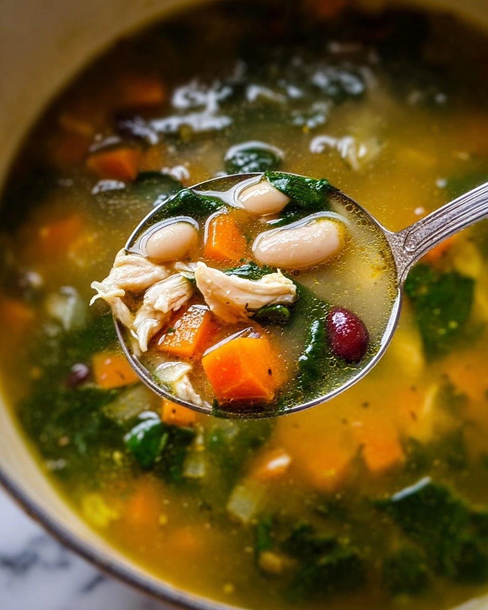 The image shows a close-up of a clear, golden broth soup filled with different ingredients. In the spoon, there are white large beans, small pieces of white chicken, bright orange carrot cubes, dark green leafy spinach, and some red kidney beans. Around the spoon, the soup has more green spinach floating in the translucent broth, with light reflections on the surface. The texture looks smooth and the vegetables and beans appear soft but whole. The background shows the soup inside a pot, with the edges blurred, over a white marbled surface. Photo taken with an iphone --ar 4:5 --v 7