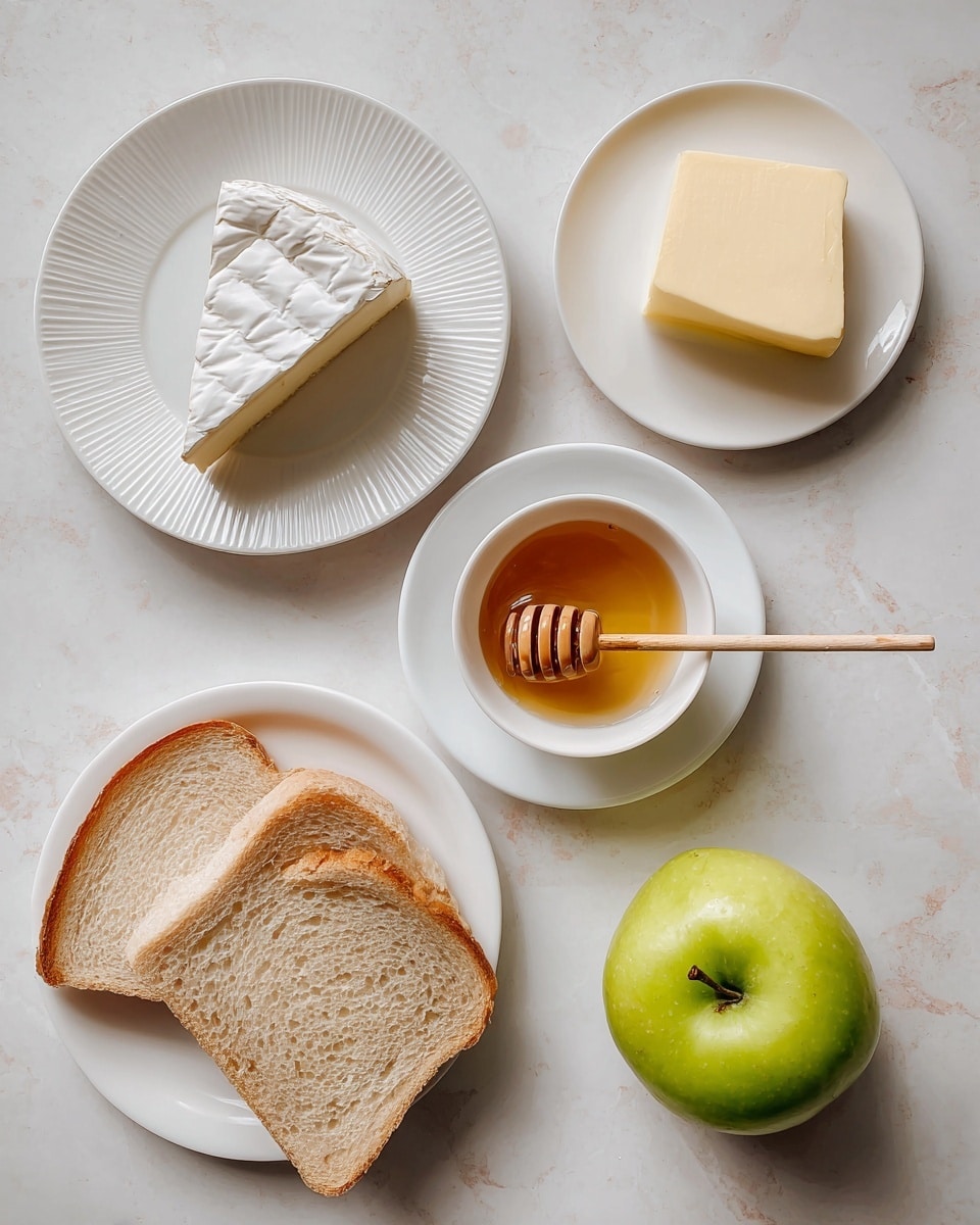 The image shows five food items placed separately on a white marbled surface. On the top left, a slice of brie cheese with a white rind and creamy interior sits on a white plate with ridges along the edge. To the top right, a small light yellow block of butter rests on a smooth white plate. Below the brie, a small white bowl filled with golden honey includes a wooden honey dipper resting inside it, placed on a matching white saucer. At the bottom left, two slices of light brown bread with soft texture are placed one overlapping the other. On the bottom right, there is a whole green apple with a smooth shiny skin. Small labels with red highlights and black text describe the items and their quantities. Photo taken with an iphone --ar 4:5 --v 7