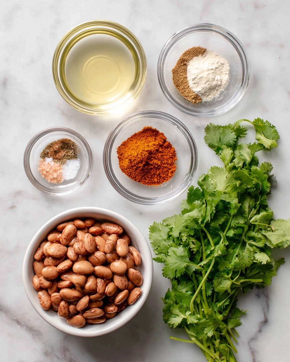 The image shows six ingredients arranged on a white marbled surface. At the bottom left, a white bowl is filled with light to dark brown pinto beans, smooth in texture. Above it, three small clear glass bowls each hold different powders: the top one with a fine white onion and garlic powder, the middle left one contains a mix of bright orange smoked paprika and light brown cumin, and the middle right one shows fine pinkish salt. To the left of the beans, a small clear bowl has pale yellow apple cider vinegar liquid. On the right side, fresh green cilantro leaves and stems lay flat, showing fine textures and different shades of green. The photo is taken with an iphone --ar 4:5 --v 7