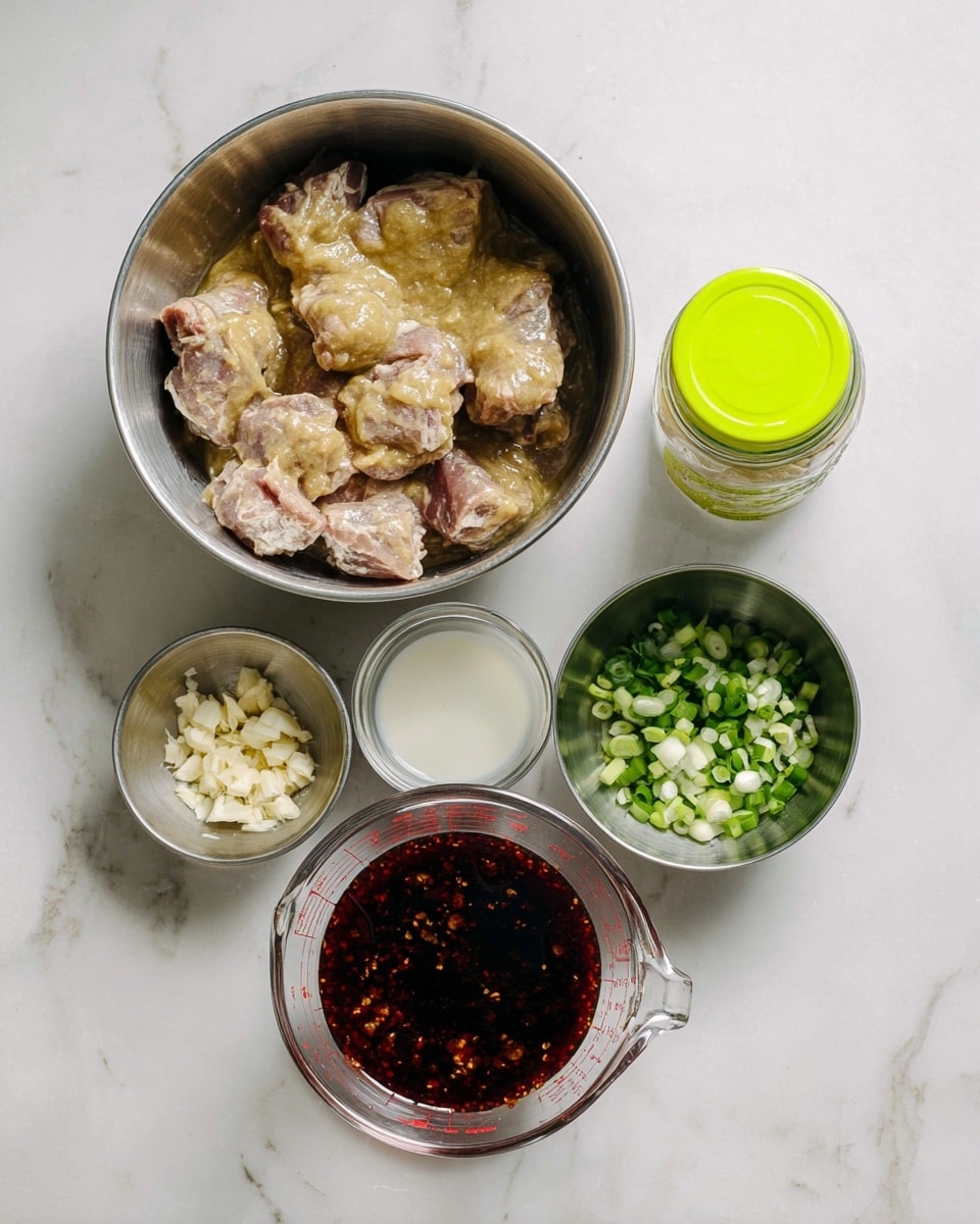 The image shows several ingredients arranged on a white marbled surface. At the top left is a metal bowl filled with pieces of meat coated in a thick, pale yellowish marinade. To the right of this bowl is a small clear jar with a bright green lid. Below the jar is a small metal bowl holding a white liquid. Next to it on the right is another metal bowl filled with chopped green onions. In the bottom center is a clear measuring cup containing a dark red liquid sauce with visible chili flakes. To the left of the measuring cup is a small metal bowl filled with minced garlic. All items are laid out neatly, showing the preparation stage of a recipe, photo taken with an iphone --ar 4:5 --v 7