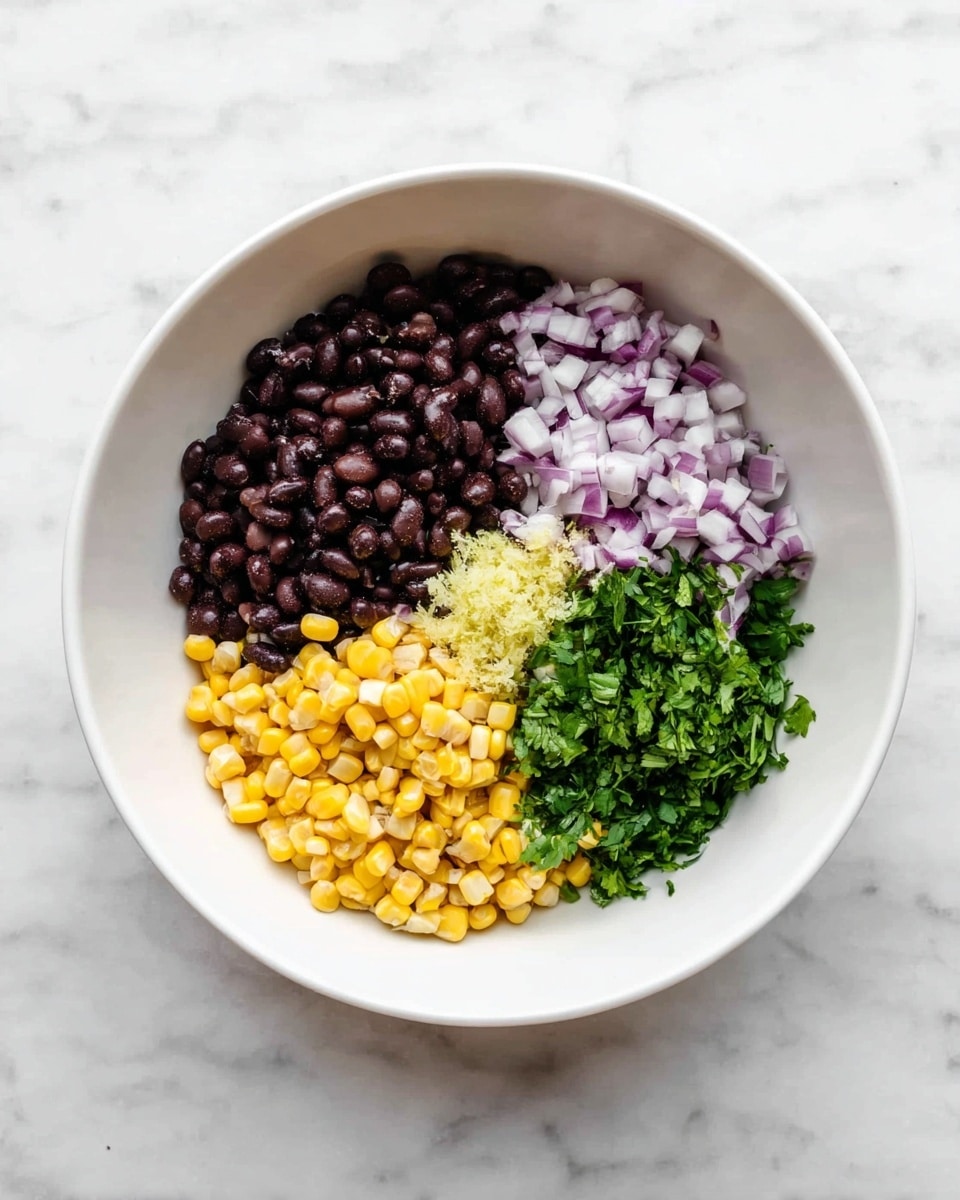 A white bowl contains five separate sections of ingredients arranged side by side: dark brown black beans in one section, small pale purple chopped onions in the next, bright yellow corn kernels beside the onions, a small pile of minced light yellow garlic near the corn, and fresh chopped green cilantro leaves next to the garlic. The bowl sits on a white marbled surface, and the image is clean and bright with a clear top-down view. Photo taken with an iphone --ar 4:5 --v 7