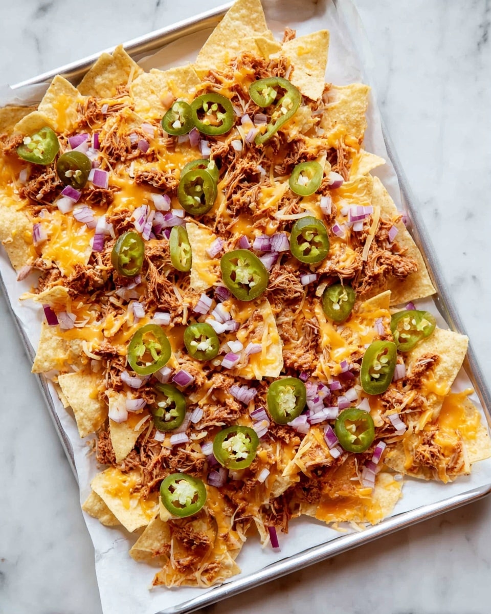A white tray holds a single layer of pale yellow tortilla chips spread evenly on white parchment paper. On top is a layer of shredded orange cheddar cheese scattered all over. Small piles of shredded brown pulled meat are distributed across the chips. Green round slices of jalapeños are spread openly, mixed with small pieces of chopped purple onions. The tray rests on a white marbled surface. photo taken with an iphone --ar 4:5 --v 7
